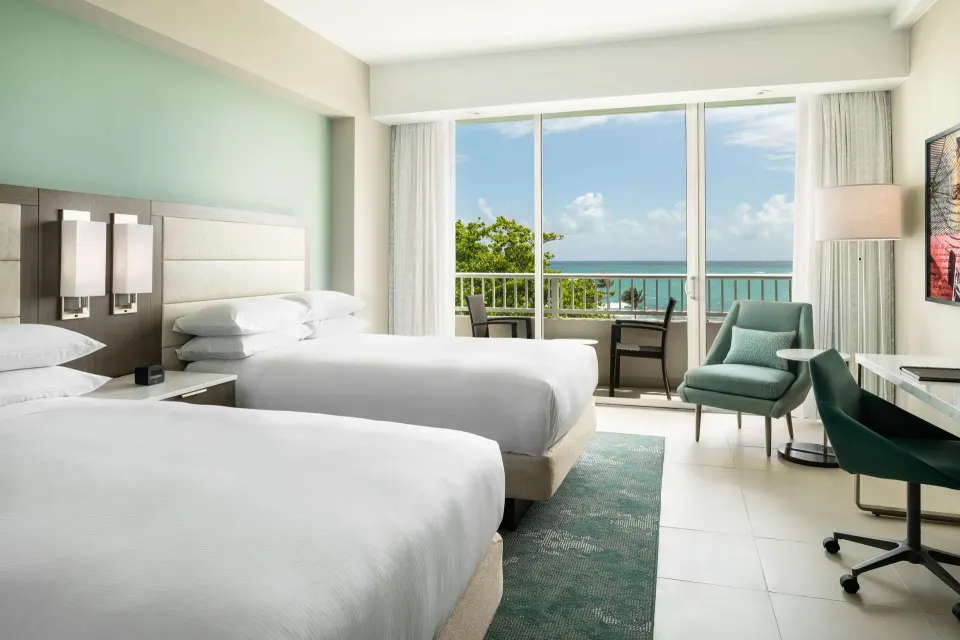 Premium Garden View room with two double beds and balcony at Caribe Hilton.