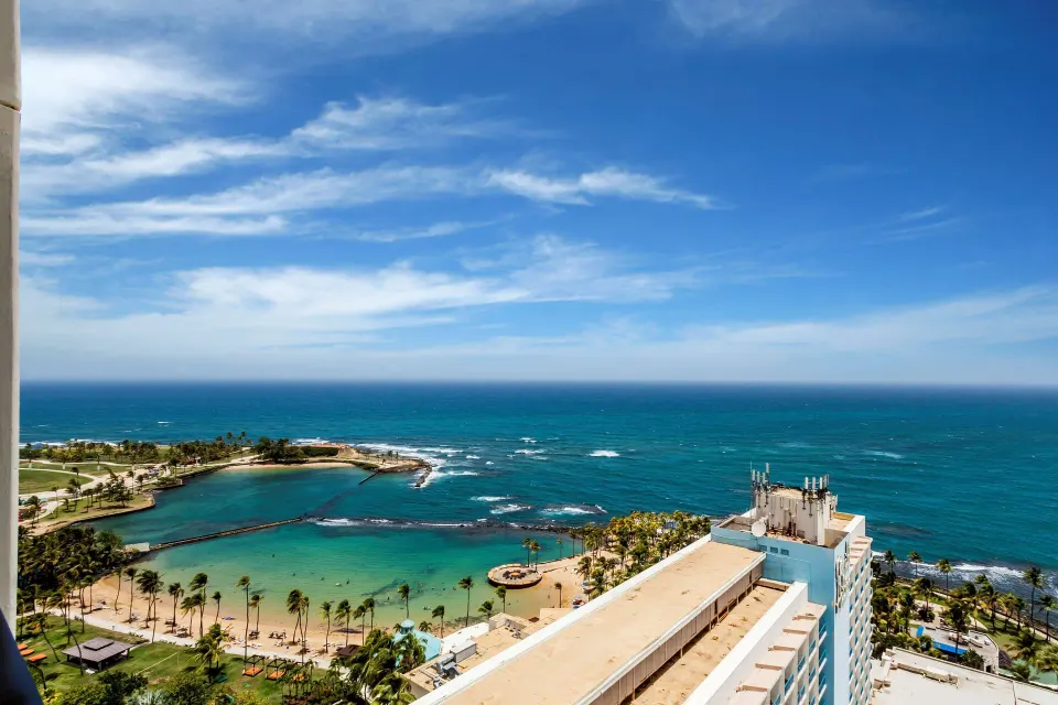Ocean and sheltered lagoon view from a guest room at Caribe Hilton.