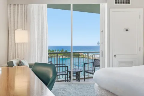 Family Connecting Junior Suite balcony view and bed at Caribe Hilton.