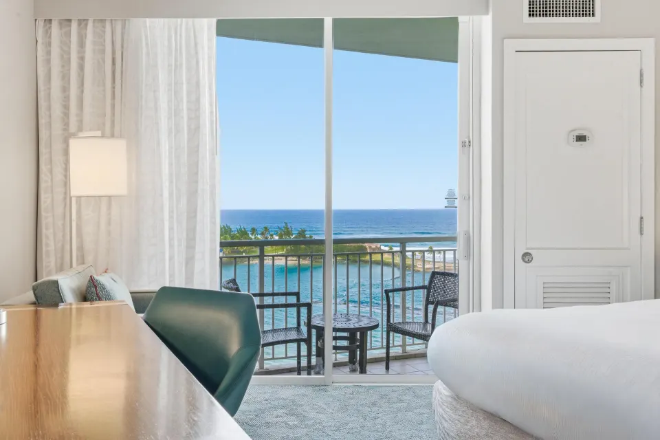Family Connecting Junior Suite balcony view and bed at Caribe Hilton.