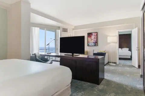 Family Connecting Junior Suite connecting rooms and TV at Caribe Hilton.