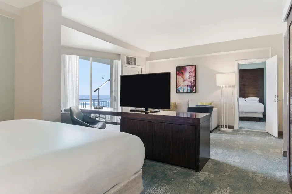 Family Connecting Junior Suite connecting rooms and TV at Caribe Hilton.