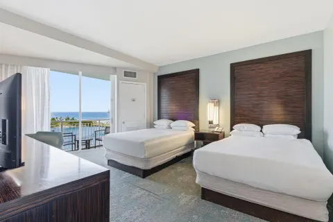 Family Connecting Junior Suite with two beds and balcony at Caribe Hilton.