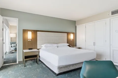 Family Room Ocean View king bed and seating area at Caribe Hilton.