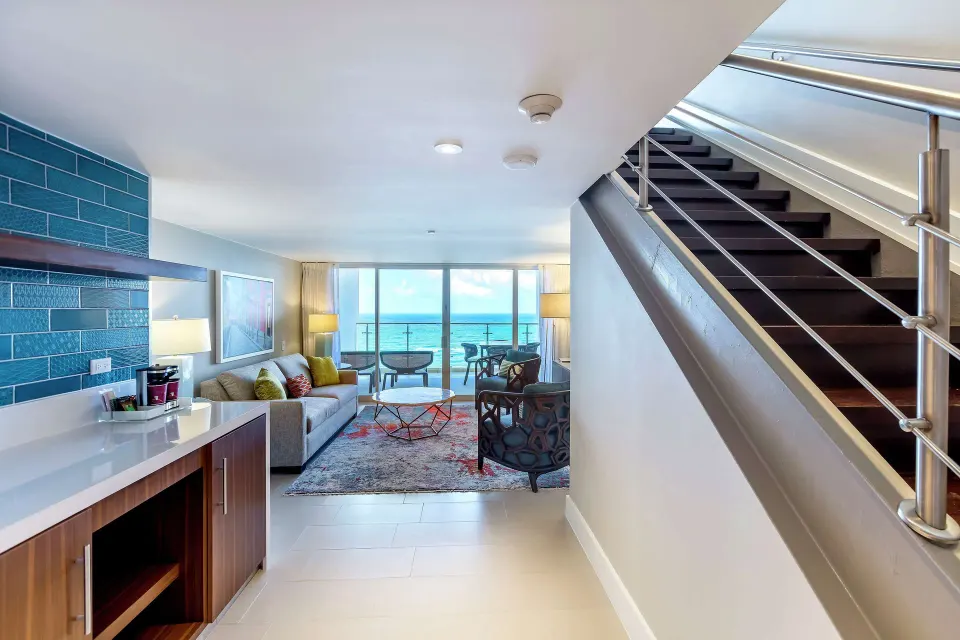 Honeymoon suite entry and ocean-facing living area at Caribe Hilton.