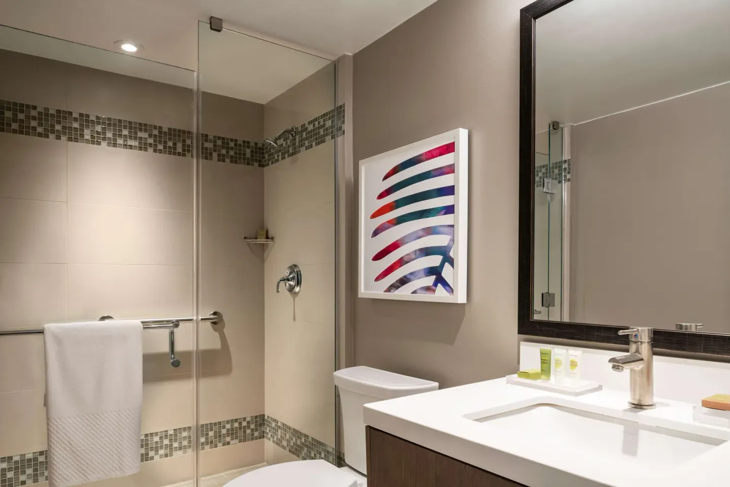 Junior suite bathroom with glass shower and vanity at Caribe Hilton.