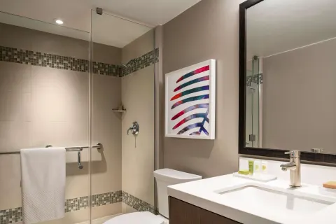 Junior suite bathroom with glass shower and vanity at Caribe Hilton.