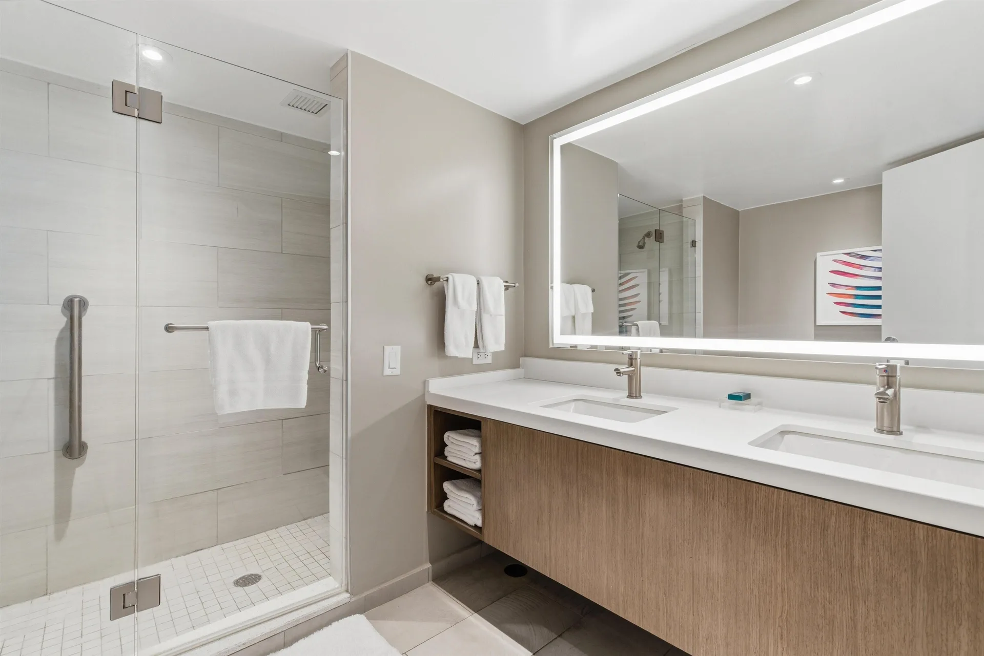 Premium Suite bathroom with glass shower and double vanity at Caribe Hilton.