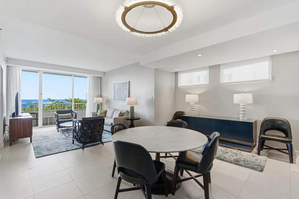 Premium Suite dining and living area with balcony doors at Caribe Hilton.