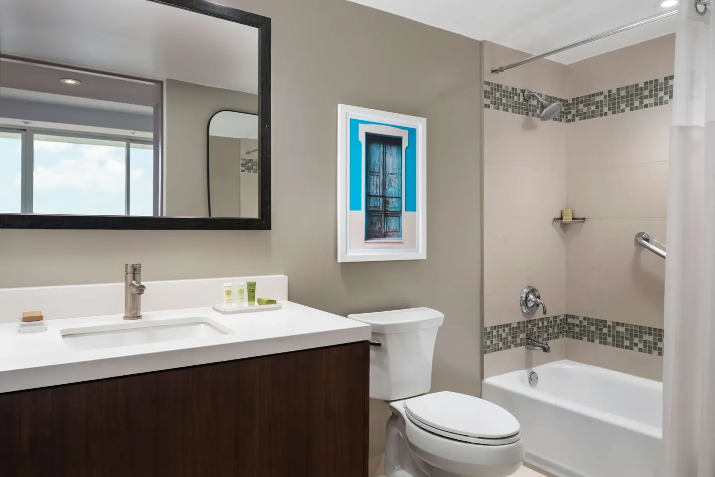 Premium suite bathroom at Caribe Hilton with vanity, toilet and tub-shower combination.