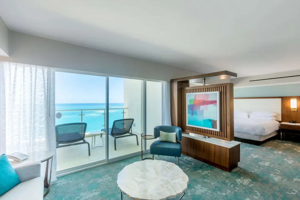 Presidential suite living area and king bedroom with ocean balcony at Caribe Hilton.