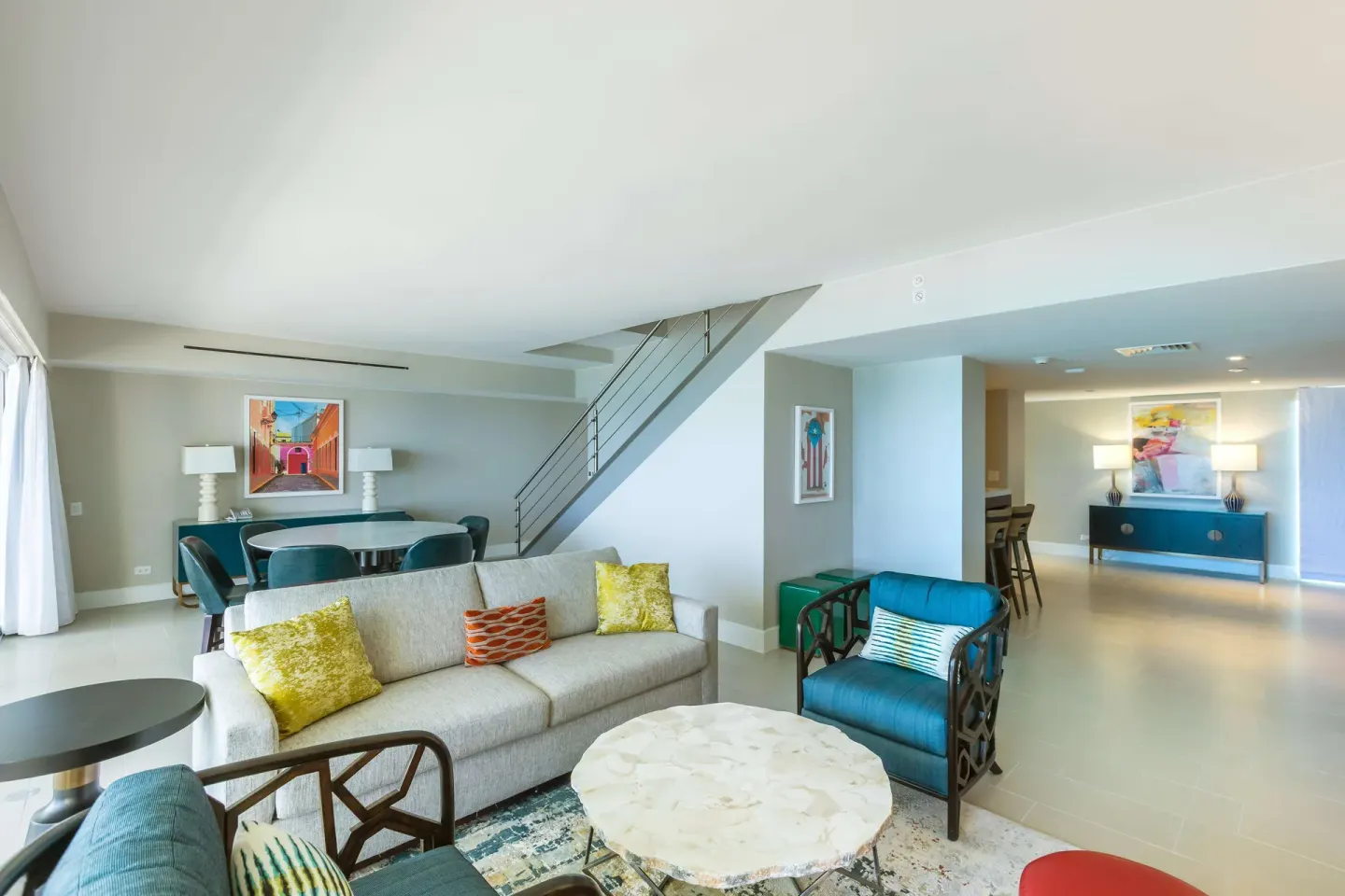 Presidential suite living and dining area with staircase at Caribe Hilton.
