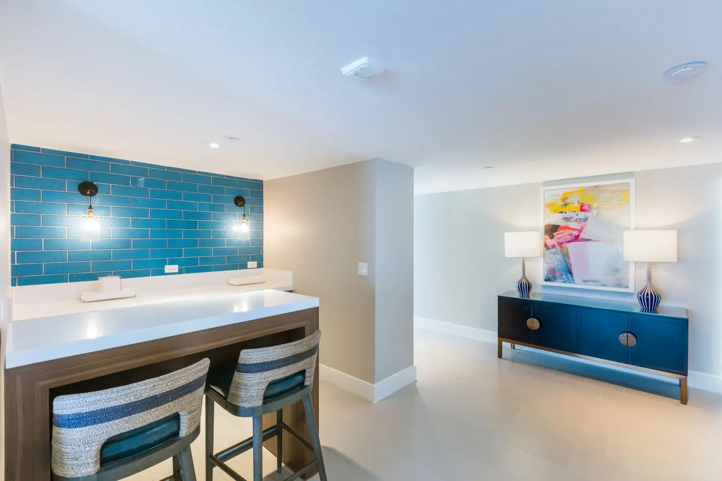 Suite wet bar with blue tile wall, stools, and sideboard at Caribe Hilton.