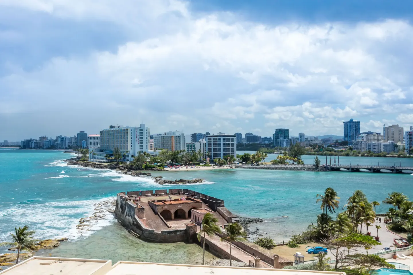 Ocean and city view from a Signature guest room at Caribe Hilton.