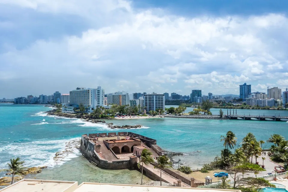 Ocean and city view from a Signature guest room at Caribe Hilton.