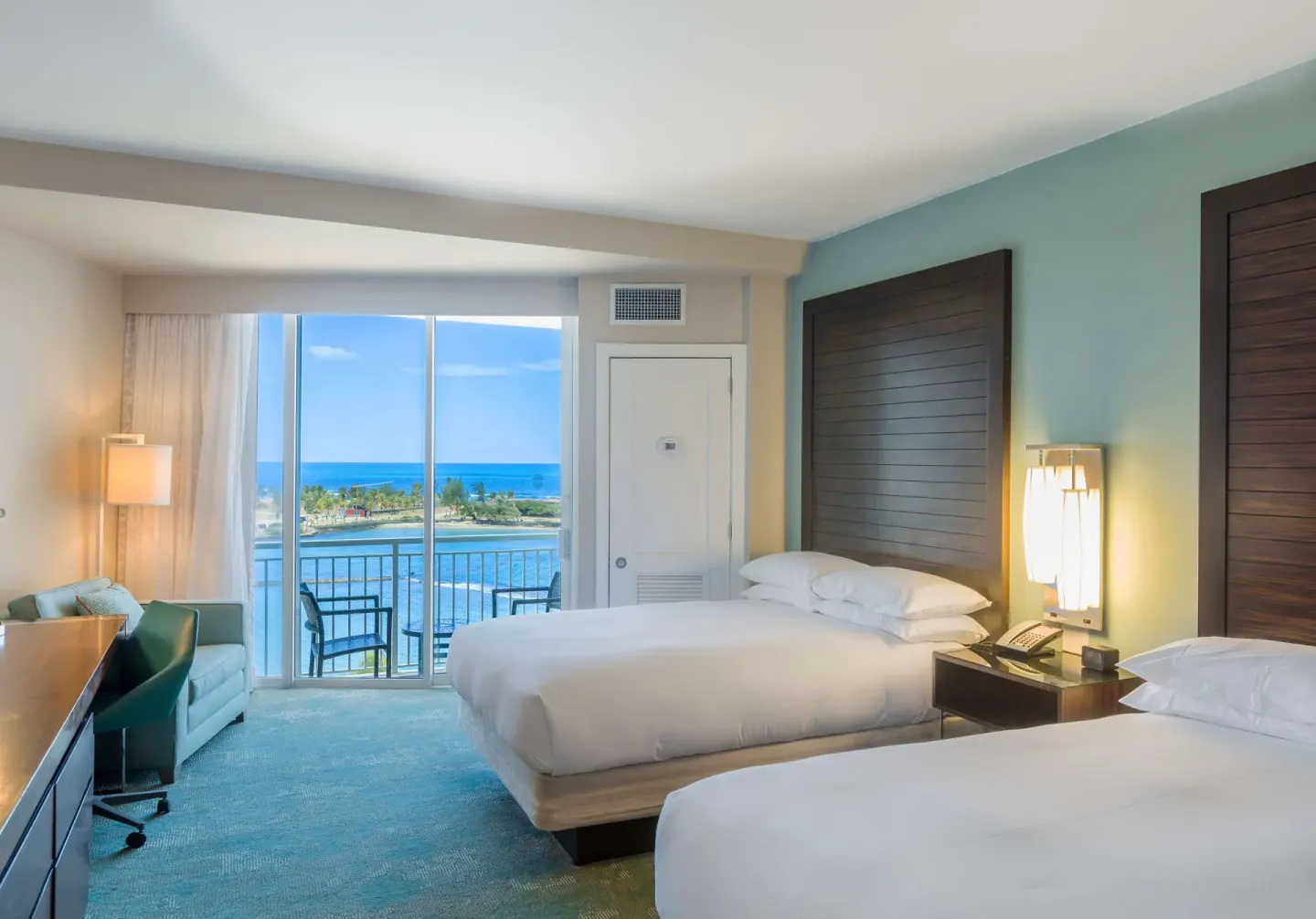 Two double beds in a premium ocean view room at Caribe Hilton.