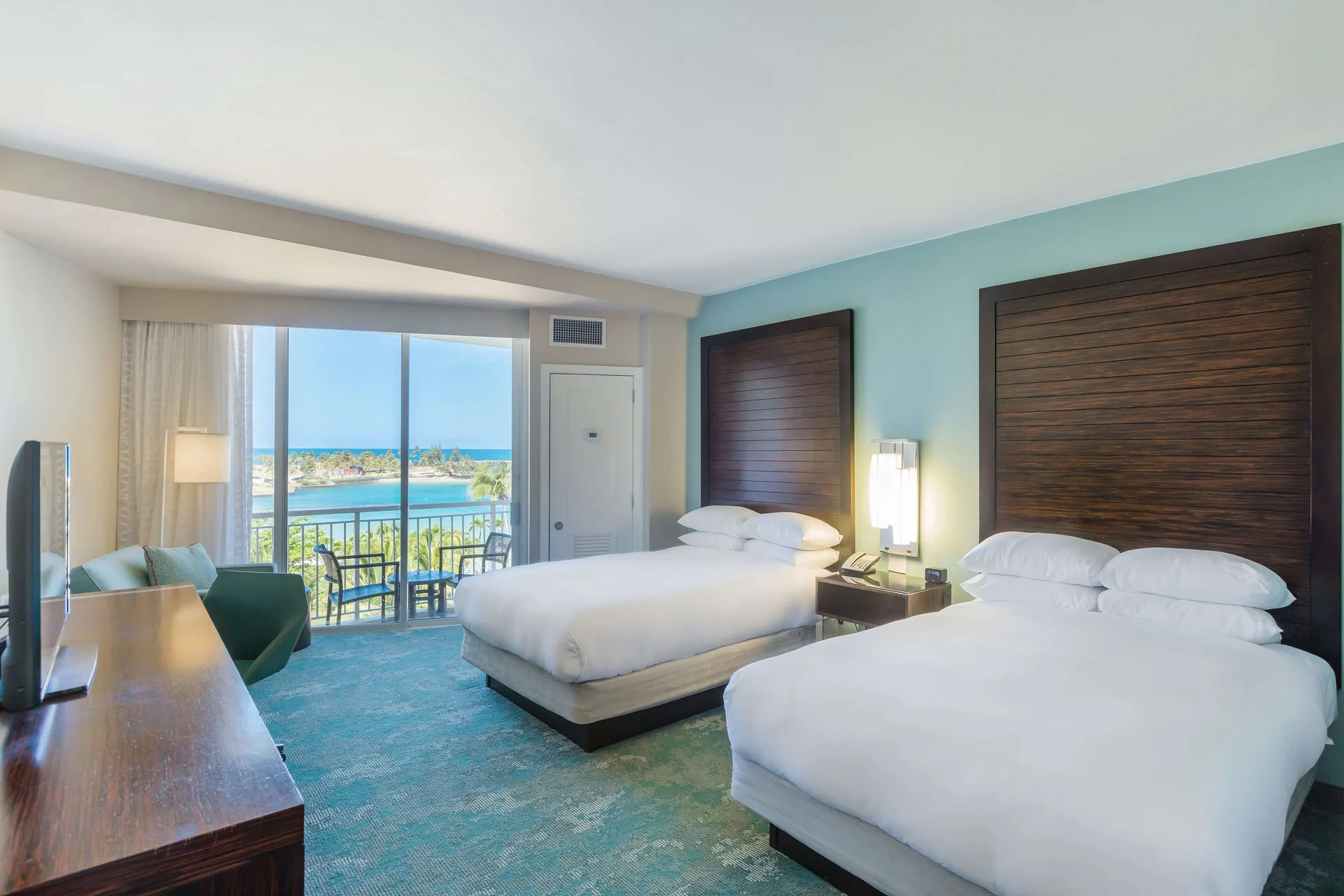 Premium ocean view room with two double beds and balcony at Caribe Hilton.