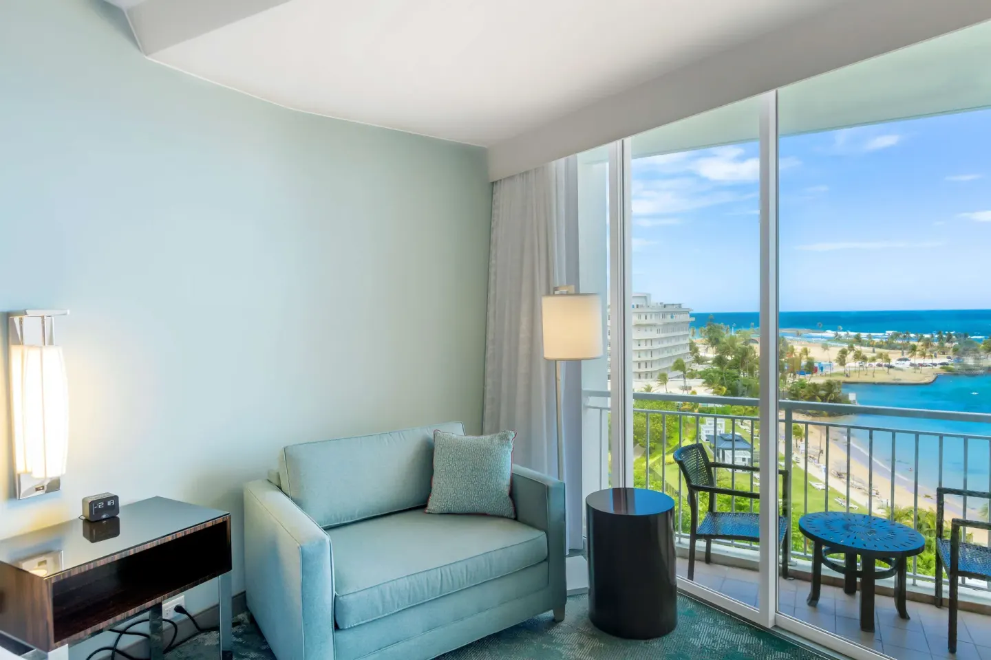 Sofa and balcony in a premium ocean view double room at Caribe Hilton.
