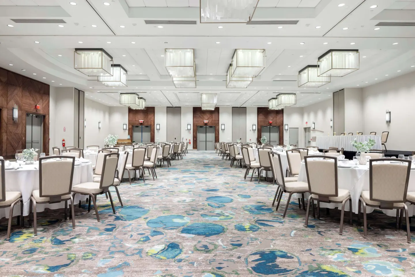 Large ballroom with banquet seating, chandeliers, and patterned carpet at Caribe Hilton.