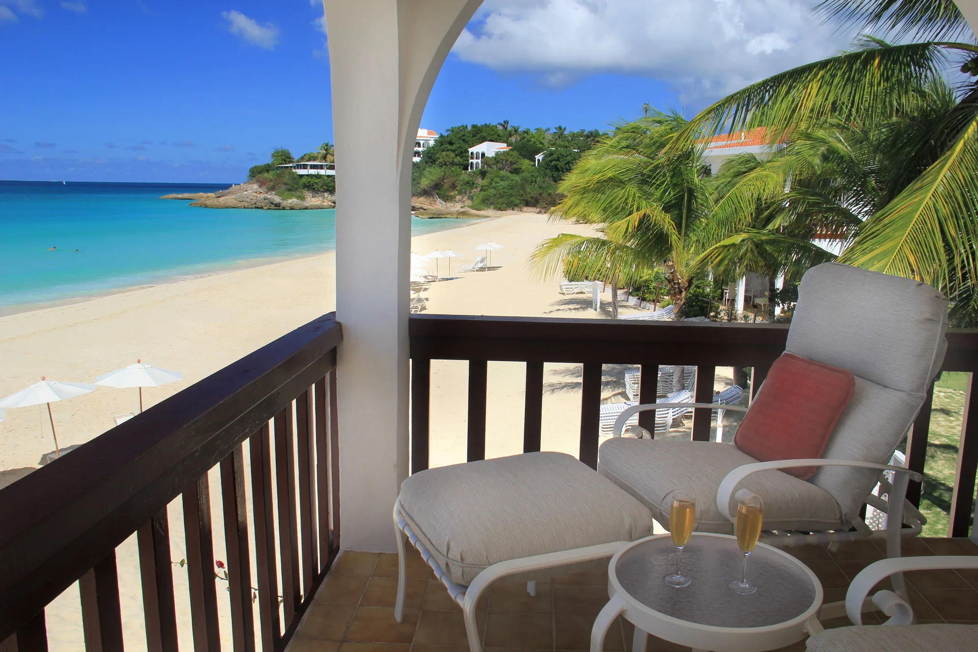 Beachfront balcony with lounge chair and ocean view at Carimar Beach Club.