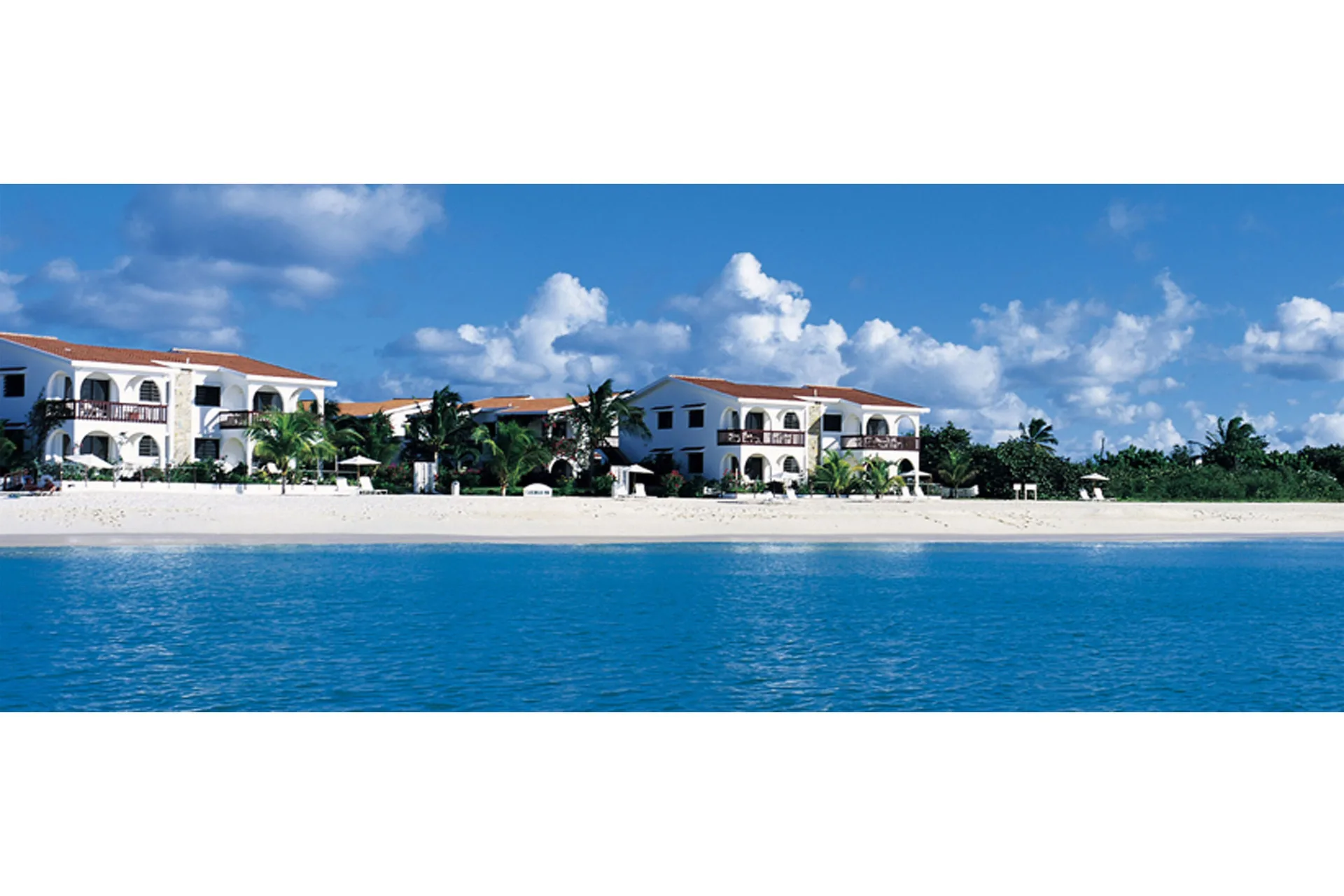 Beachfront resort buildings and turquoise water at Carimar Beach Club.