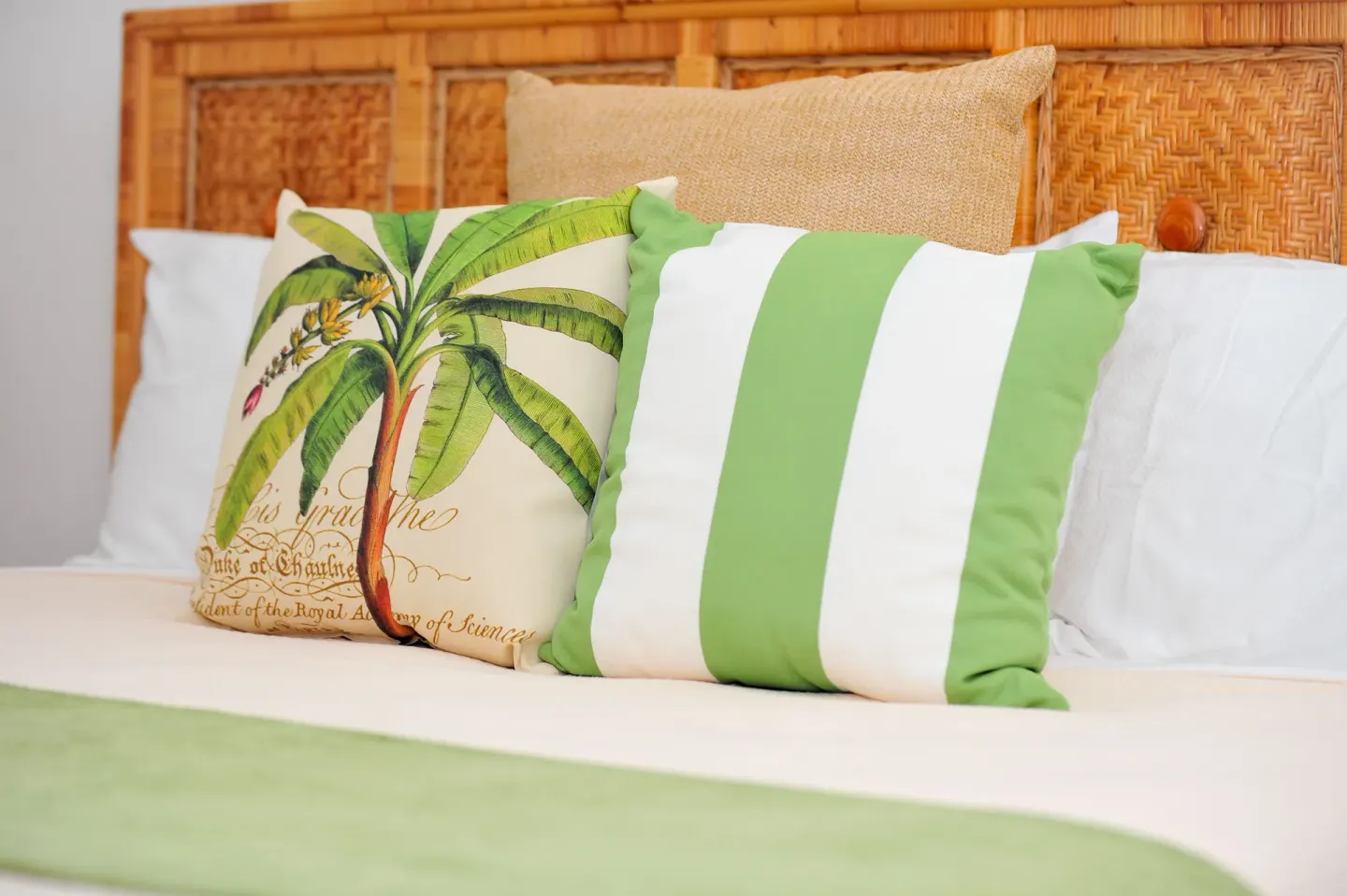 Close-up of bed pillows with green accents at Carimar Beach Club.