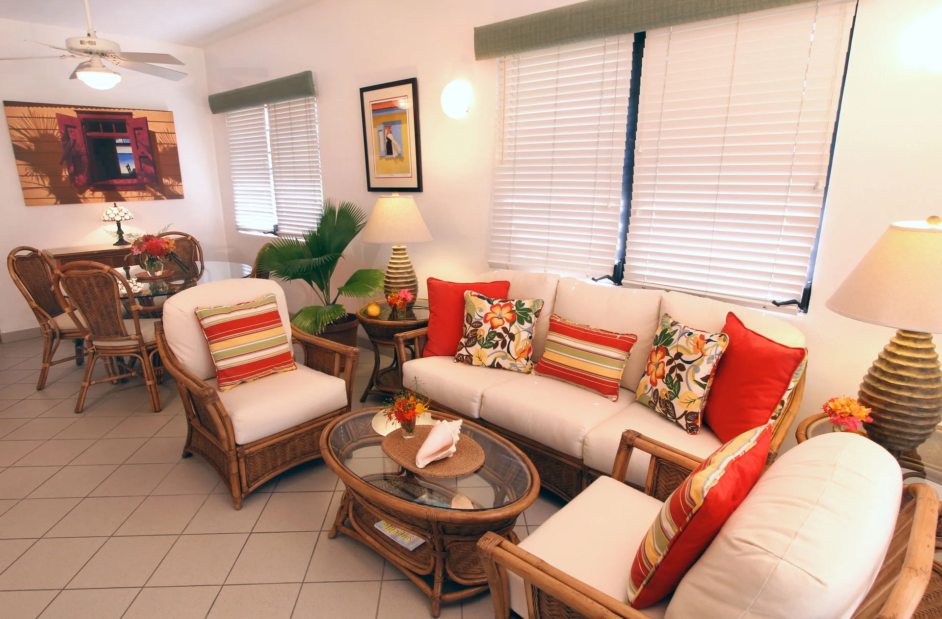 Bright living and dining area with wicker seating at Carimar Beach Club.