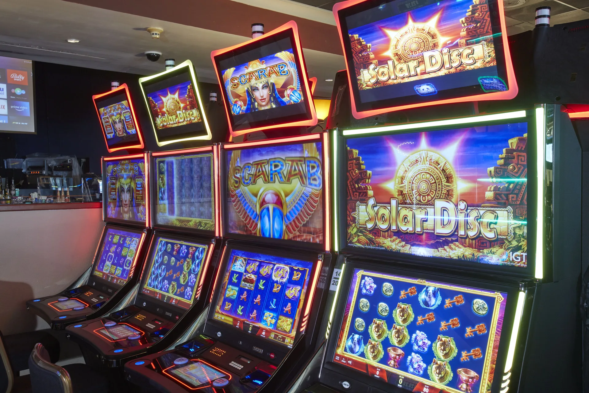 Colorful slot machines inside the casino at Carina Bay Boutique Resort & Casino.