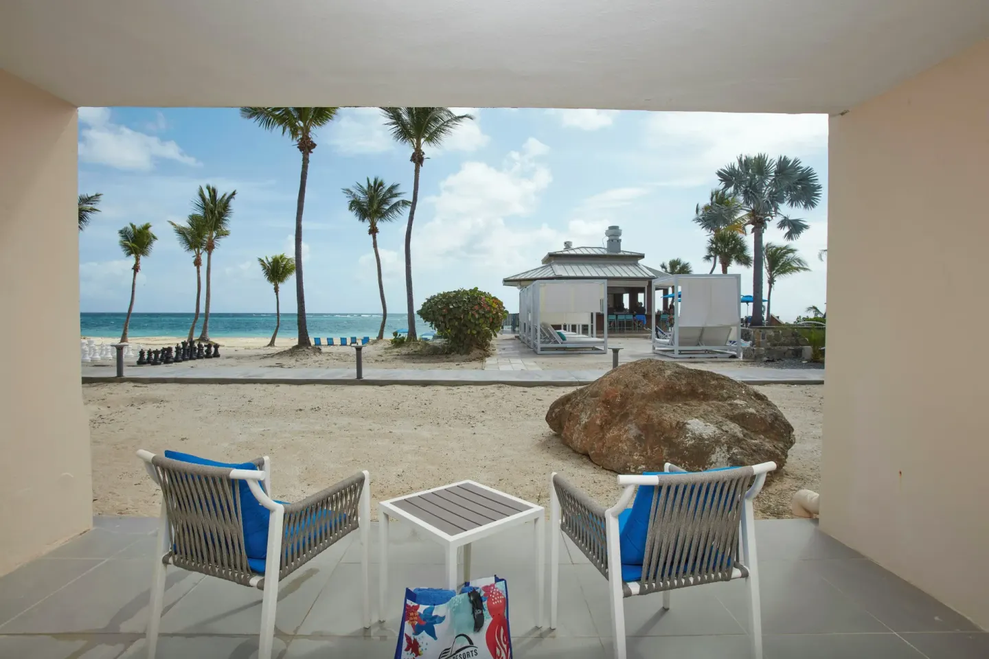 Ground-floor patio facing the beach at Carina Bay Boutique Resort & Casino.