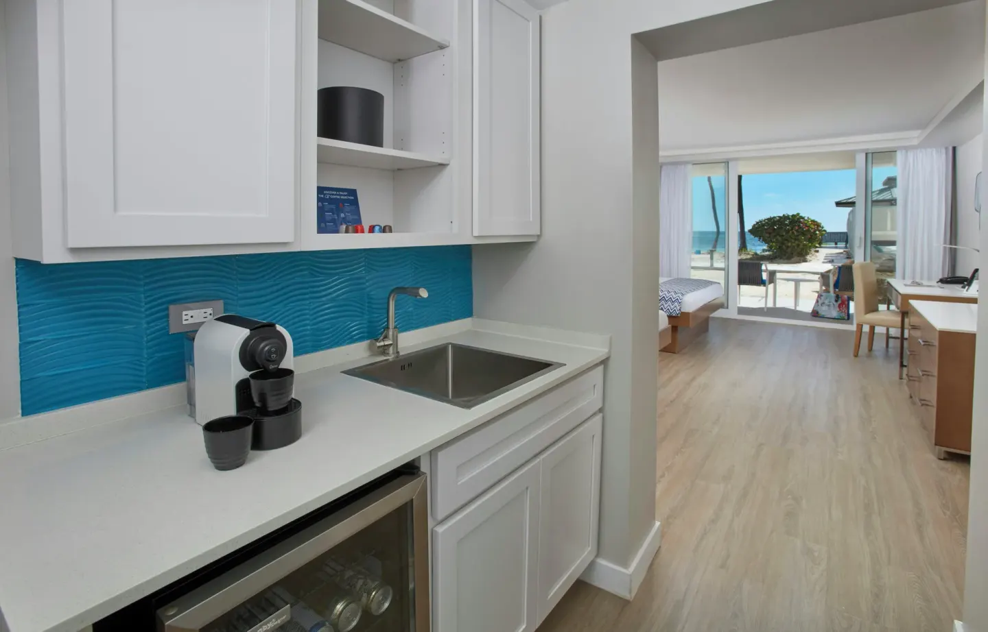 Guest room kitchenette with blue backsplash at Carina Bay Boutique Resort & Casino.