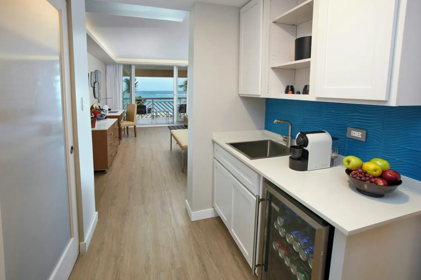 Guest room kitchenette and ocean balcony at Carina Bay Boutique Resort & Casino.
