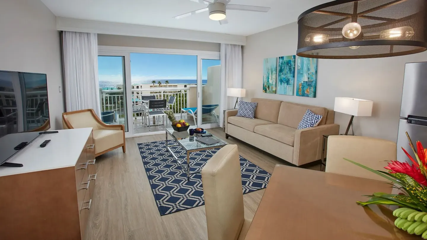 Living area with balcony and ocean view at Carina Bay Boutique Resort & Casino.