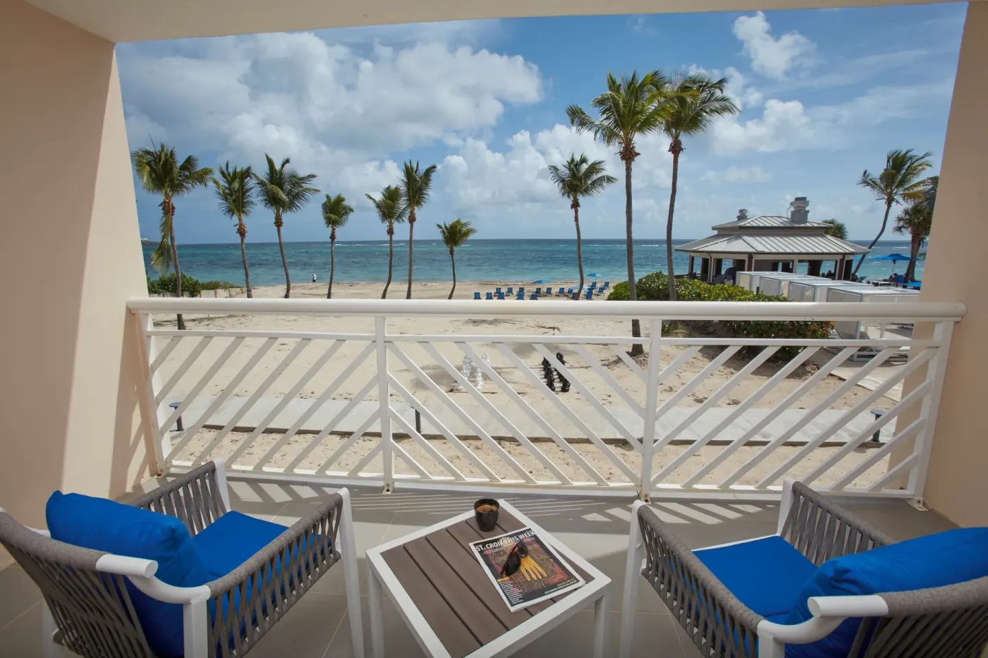 Beachfront room balcony with chairs and ocean view at Carina Bay Boutique Resort & Casino.