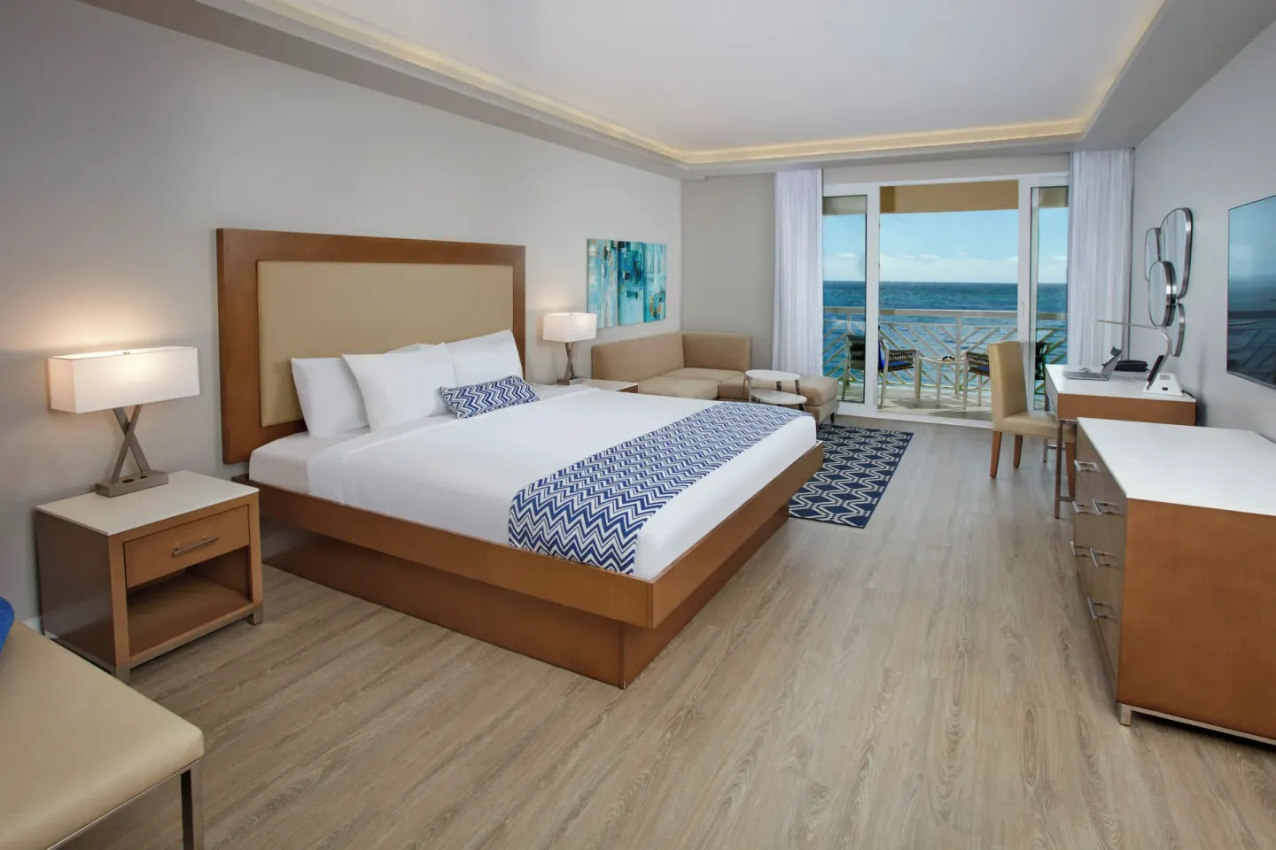 Beachfront king room with balcony and ocean view at Carina Bay Boutique Resort & Casino.