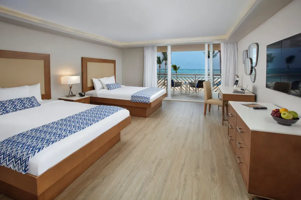 Beachfront two-bed room with balcony and ocean view at Carina Bay Boutique Resort & Casino.
