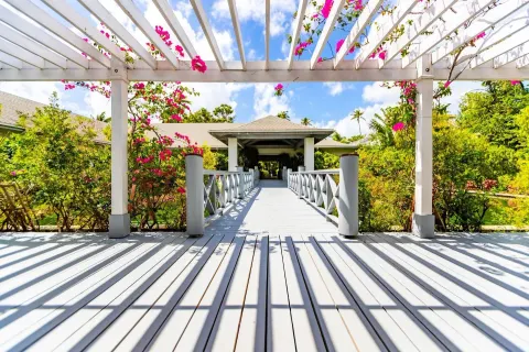 White pergola walkway with bougainvillea in the gardens at Carlisle Bay.