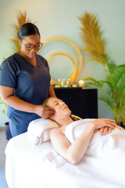 A guest receives a facial treatment in the spa at Carlisle Bay.