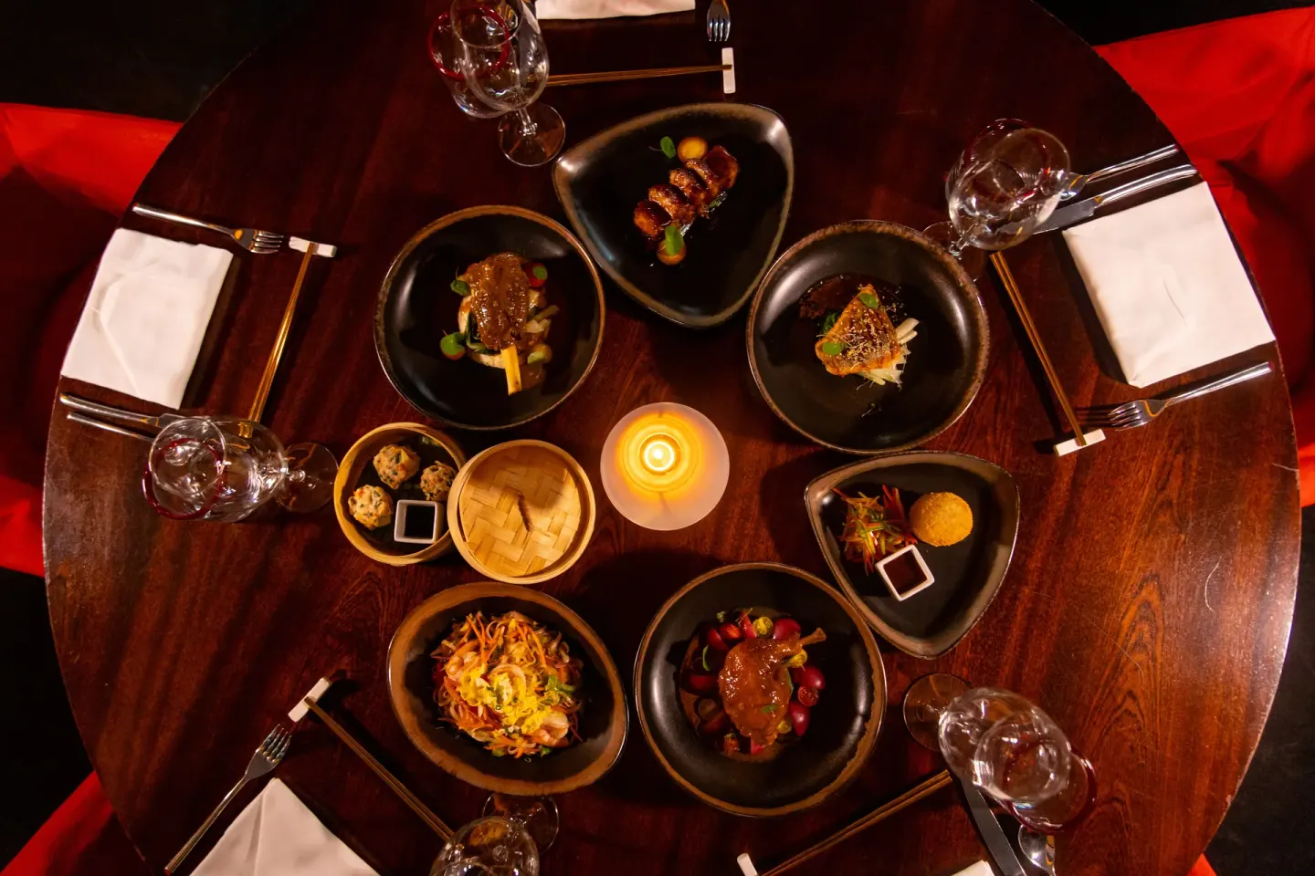 Overhead view of Asian dishes on a round table at Carlisle Bay.