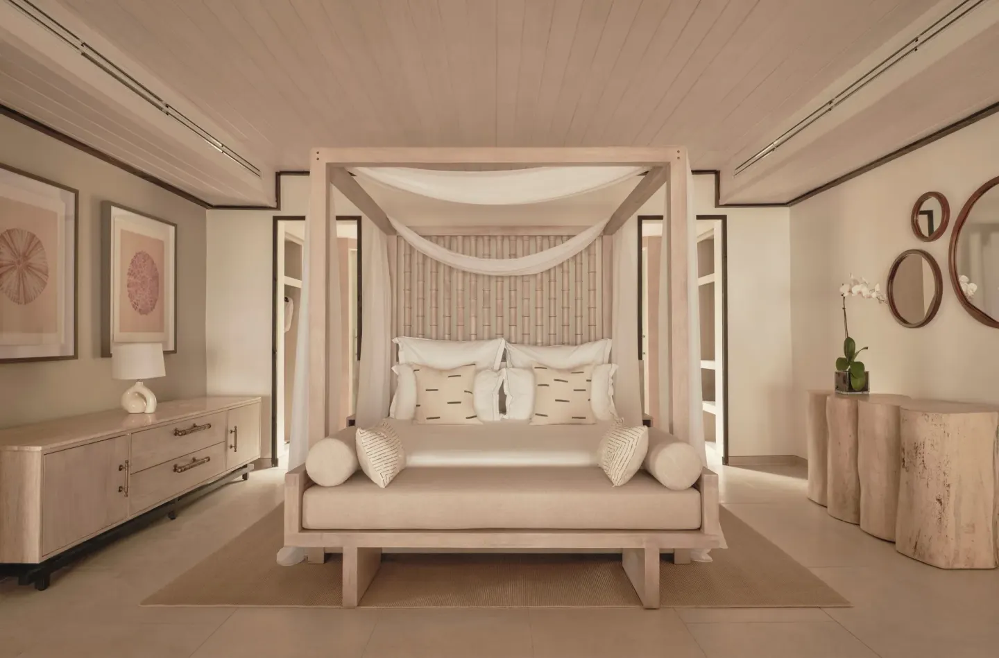 Bay Suite canopy king bed with bedside furnishings at Carlisle Bay.