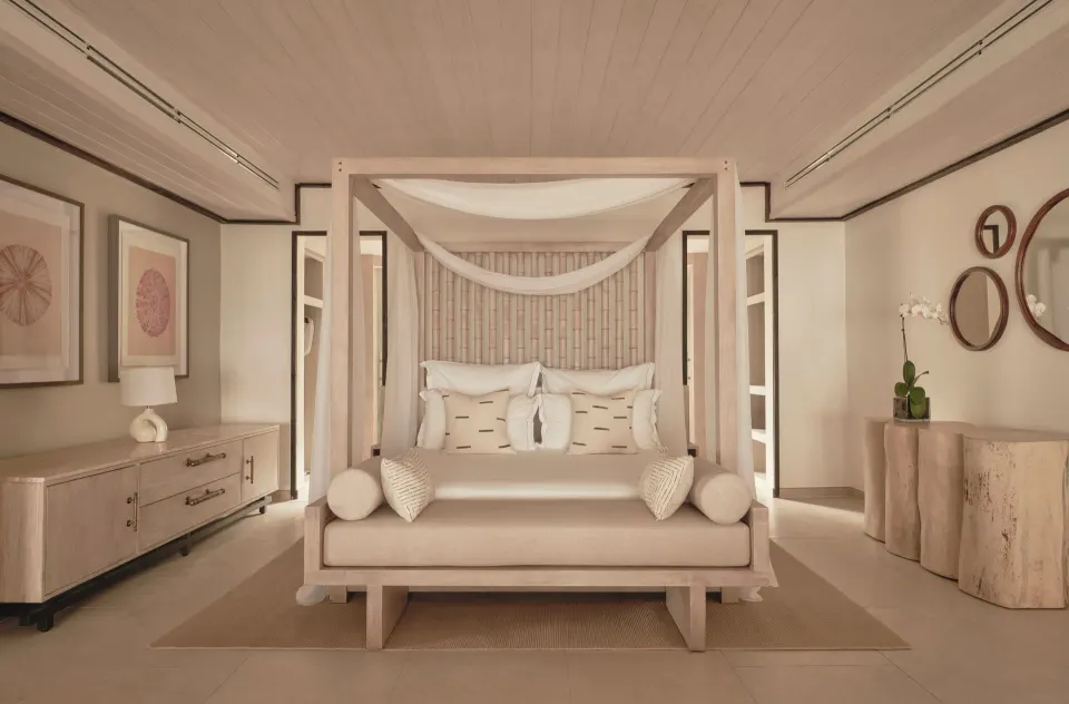 Bay Suite canopy king bed with bedside furnishings at Carlisle Bay.