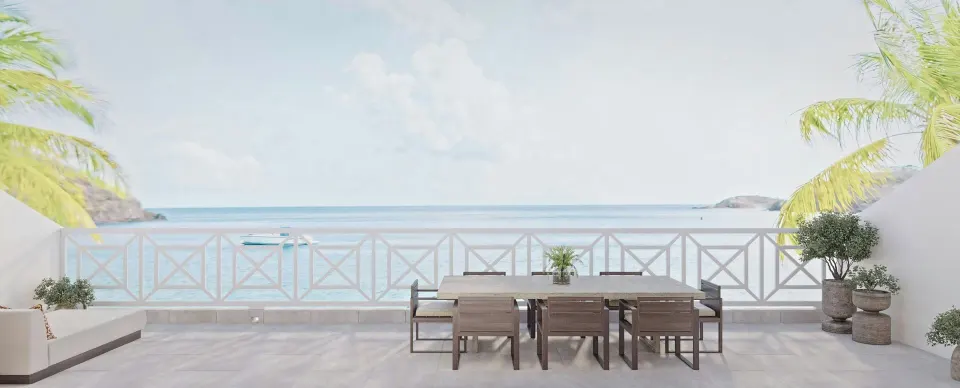 Oceanfront terrace with dining table at the Carlisle Bay at Carlisle Bay.
