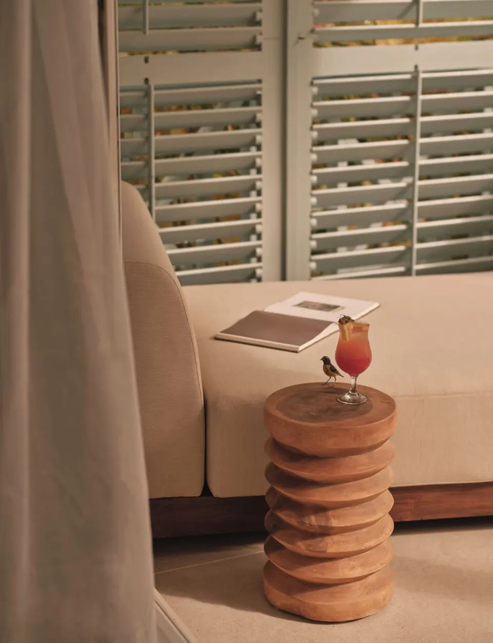 Ocean Suite daybed and side table with a drink at Carlisle Bay.