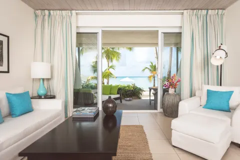 Sitting area in a Terrace beach suite at Carlisle Bay with sliding doors to the beach.