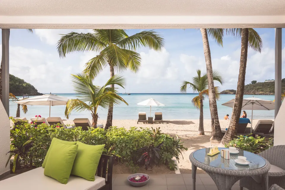 Terrace beach suite patio at Carlisle Bay with seating facing the sand and sea.