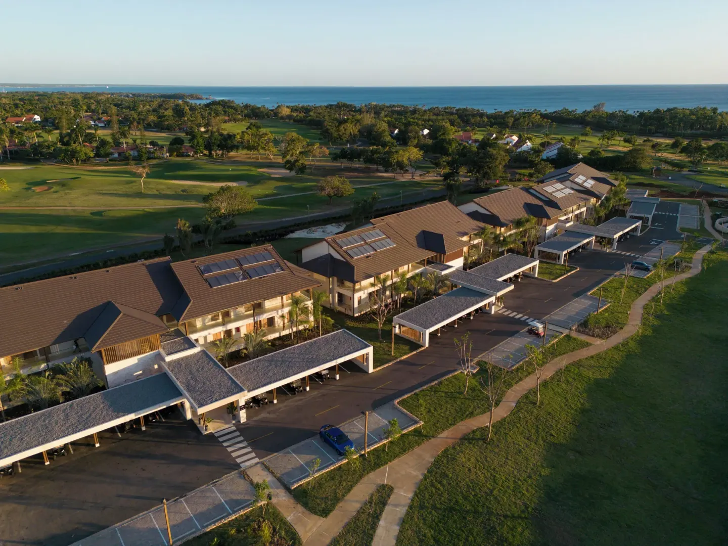 Aerial view of resort buildings, golf greens, and ocean at Casa de Campo Resort and Villas and Villas and Villas.