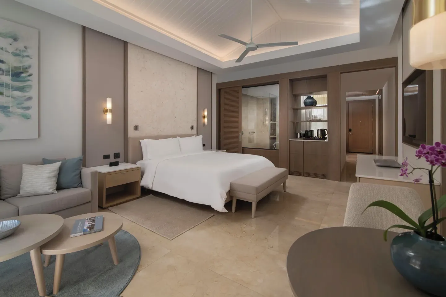 Modern guest room with king bed and sitting area at Casa de Campo Resort and Villas and Villas and Villas.