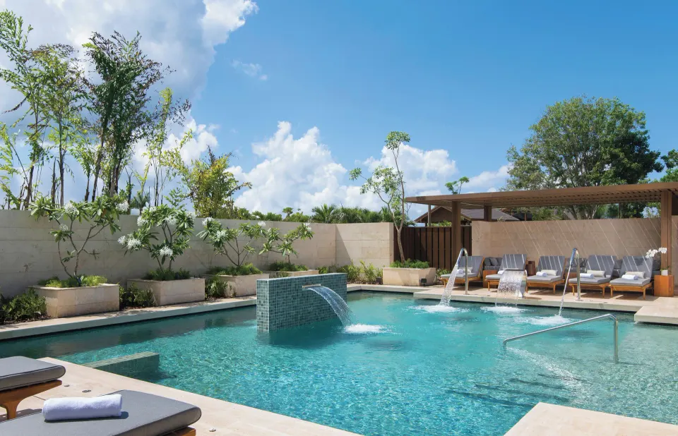 Spa pool with water features and lounge seating at Casa de Campo Resort and Villas and Villas and Villas.