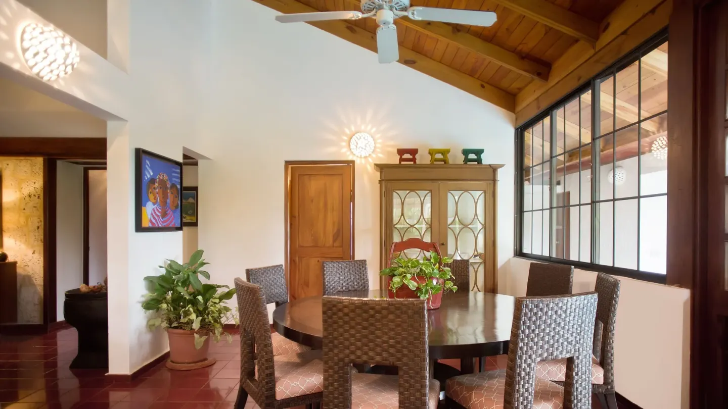 Villa dining room with round table and wood ceiling at Casa de Campo Resort and Villas and Villas and Villas.