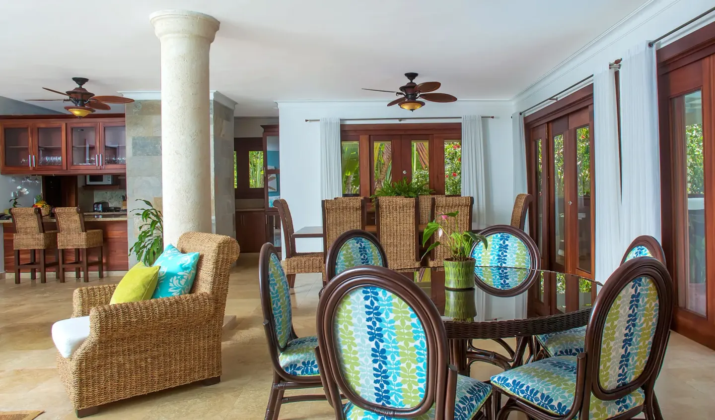 Villa living and dining space with kitchen and glass doors at Casa de Campo Resort and Villas and Villas and Villas.