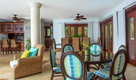 Villa living and dining space with kitchen and glass doors at Casa de Campo Resort and Villas and Villas and Villas.